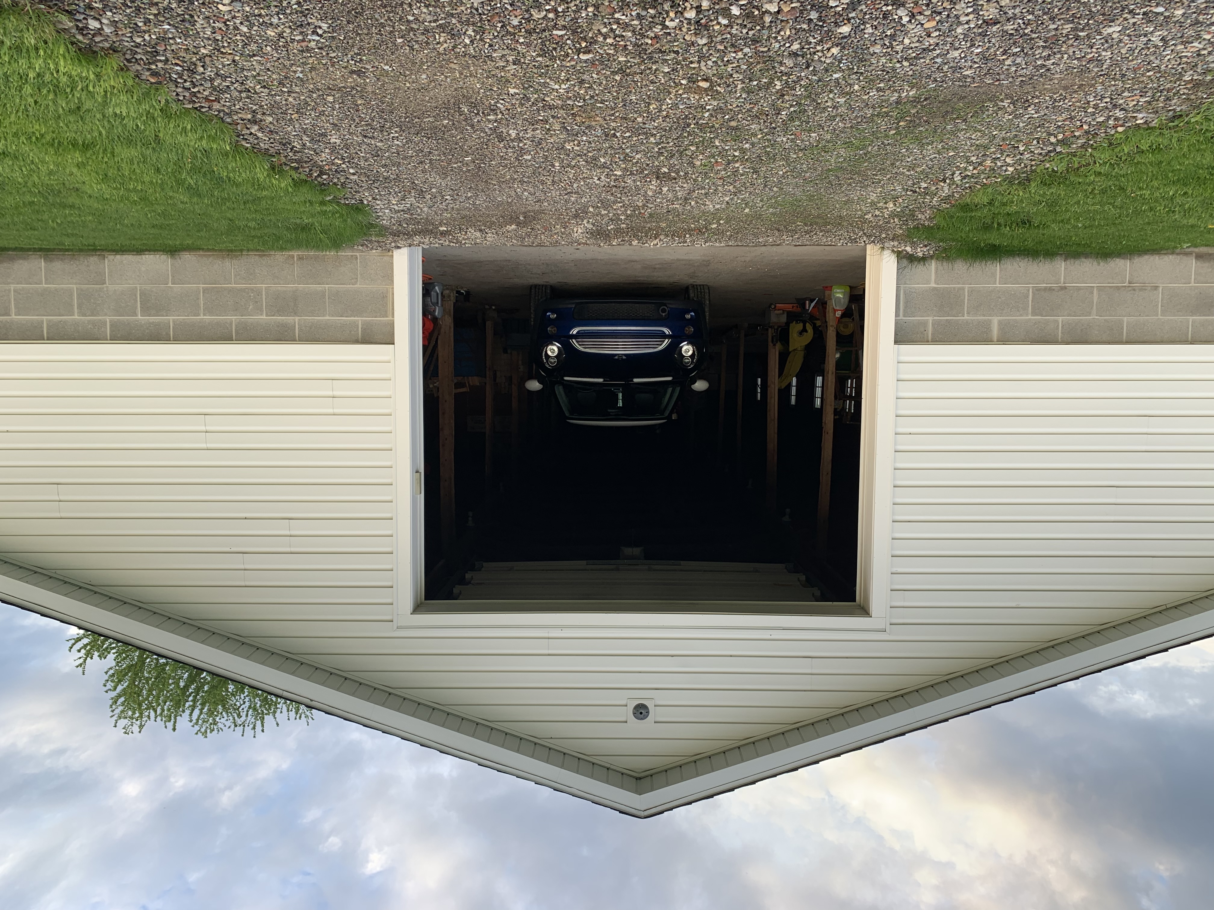 car peeking out of barn door